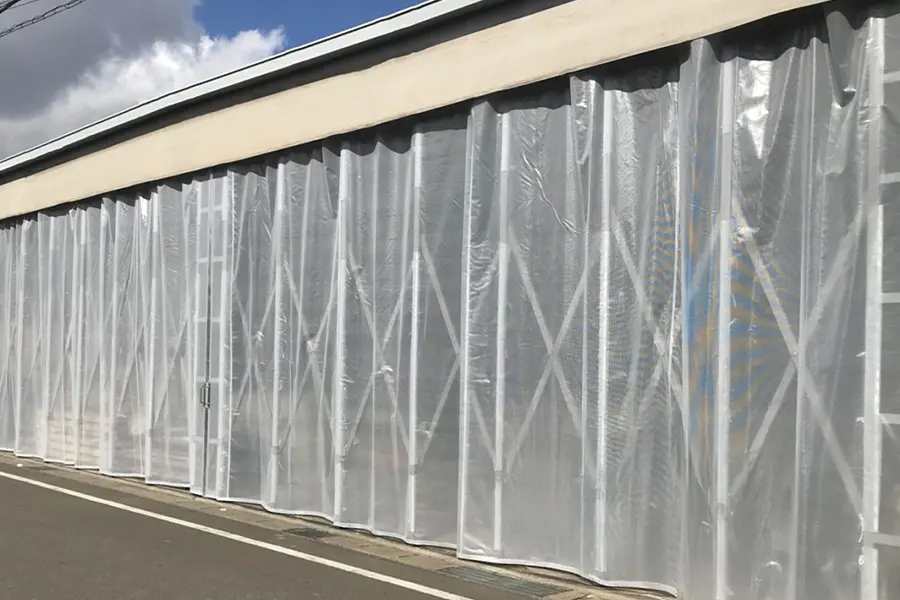 ET-1600S 糸入り透明ビニールシートを使用した建物外壁の全体間仕切り施工(屋外風よけ・採光対応)